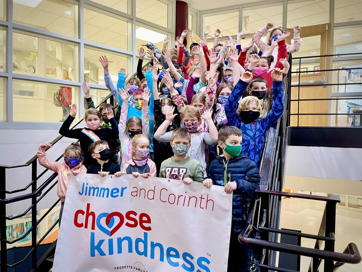Group of kids holding a Choose Kindness banner in a school